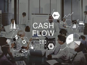 Business people with the words "cash flow" over the to illustrate cash is king.