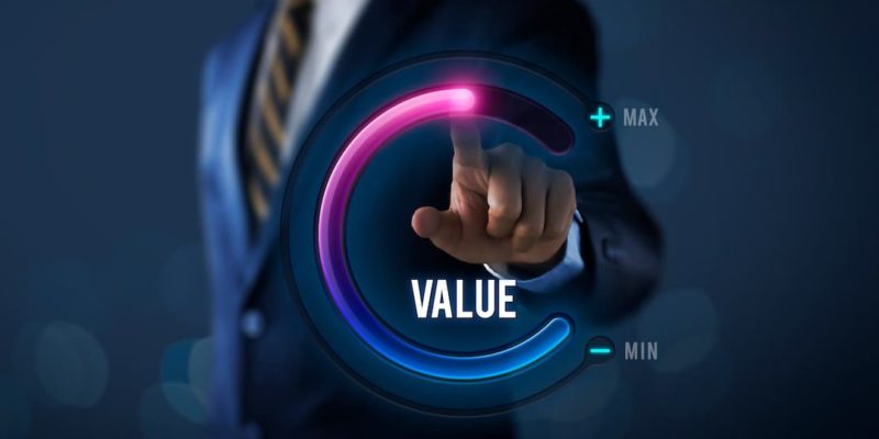 Image of a business person turning a dial from min to max value to illustrate how to value a business.