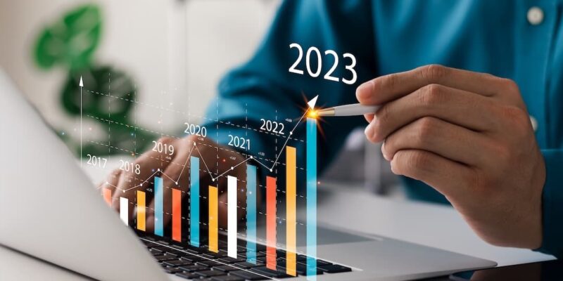 Business person showing trend chart to illustrate business trends 2023 blog post.