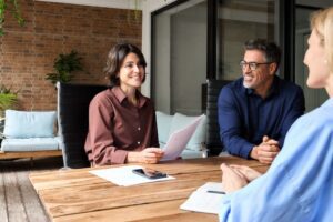 Business people talking to illustrate concept of questions to ask a CHRO in an interview.