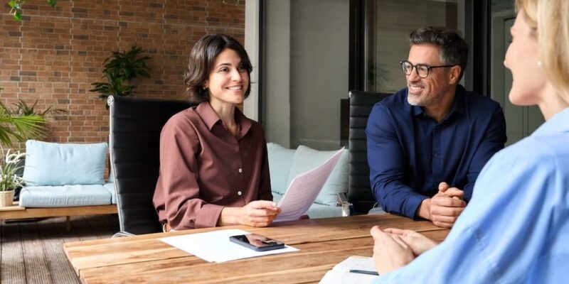 Business people talking to illustrate concept of questions to ask a CHRO in an interview.