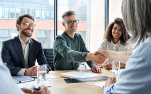 Business people shaking hands to illustrate a successful M&A process.