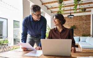 Two executives working to illustrate a blog post titled, "What is a Fractional CFO.