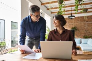 Two executives working to illustrate a blog post titled, "What is a Fractional CFO.