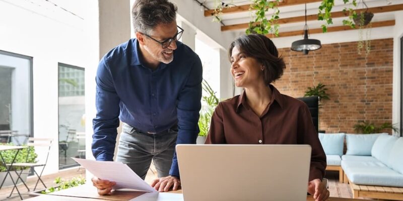 Two executives working to illustrate a blog post titled, "What is a Fractional CFO.