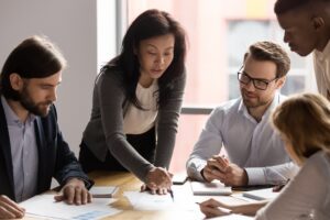 Executives discussing the results of a financial report to illustrate a blog post titled "What is Financial Reporting."