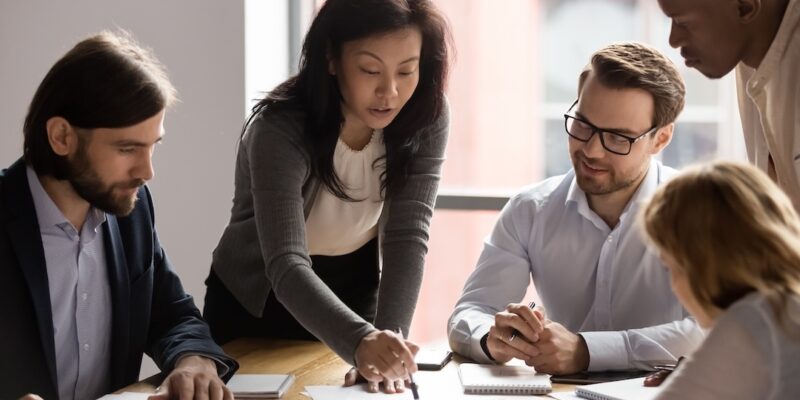 Executives discussing the results of a financial report to illustrate a blog post titled "What is Financial Reporting."