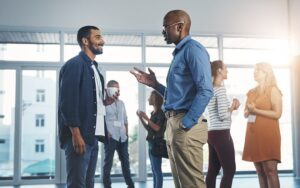 Employees discussing a job sharing arrangement to illustrate an article about flexibility in the workplace.