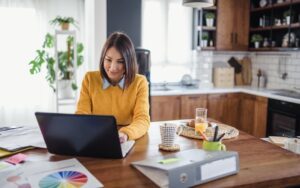 Woman working from home to illustrate a blog post about workplace flexibility.