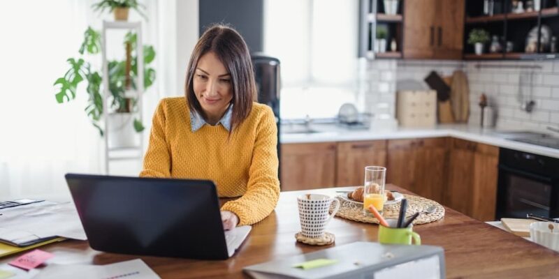 Woman working from home to illustrate a blog post about workplace flexibility.