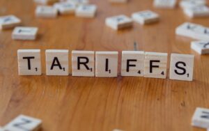The word "tariffs" spelled out in scrabble tiles.
