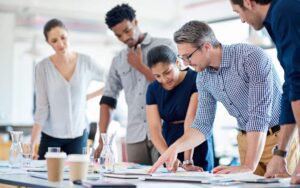 Business people working on a plan to illustrate a blog post about the business trends of 2026 and what business leaders can do.