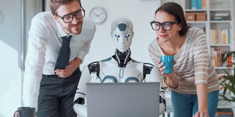 Founders working with a robot, to illustrate the dangers of relying completely on an AI CFO.