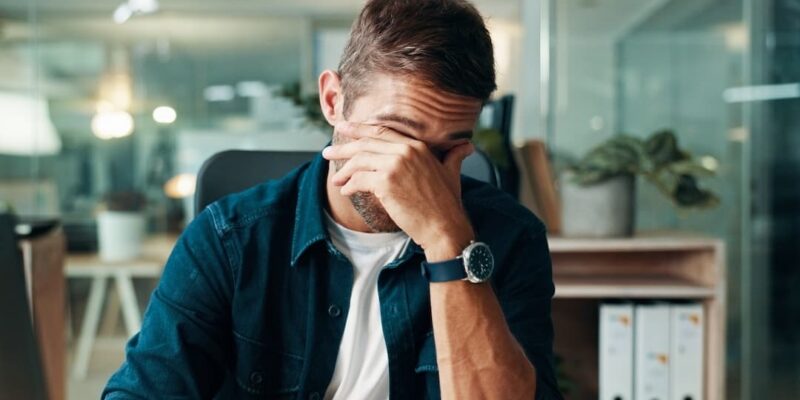 Founder with hands over their eyes to illustrate a blog posts about the 5 mistakes founders make when selling their companies.